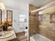 Updated bathroom with shower, modern tile, vanity and natural light at 5845 W Portland Dr, Littleton, CO 80128