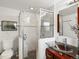 Bathroom featuring a modern glass shower, updated toilet, and vanity with a vessel sink at 5845 W Portland Dr, Littleton, CO 80128