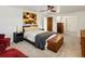 Bedroom showcasing a cozy carpet, a ceiling fan, a comfortable bed, and tasteful wall art at 5845 W Portland Dr, Littleton, CO 80128
