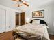 Bright bedroom featuring hardwood floors, a ceiling fan and comfortable bedding at 5845 W Portland Dr, Littleton, CO 80128