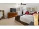 Bedroom with carpeted flooring and large windows allowing abundant natural light, accentuating a dresser at 5845 W Portland Dr, Littleton, CO 80128