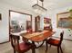 Elegant dining room with chandelier and views into the living room and kitchen at 5845 W Portland Dr, Littleton, CO 80128