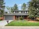 Charming two-story home featuring a well-manicured front yard at 5845 W Portland Dr, Littleton, CO 80128
