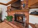 Close up of brick fireplace with mantle and flatscreen TV at 5845 W Portland Dr, Littleton, CO 80128