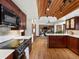 View of kitchen leading to living room with wood ceiling and hardwood floors at 5845 W Portland Dr, Littleton, CO 80128