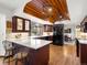 Modern kitchen with wooden ceiling, granite countertops and dark wood cabinets at 5845 W Portland Dr, Littleton, CO 80128