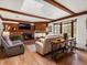 Cozy living room with brick fireplace, hardwood floors and wood beams at 5845 W Portland Dr, Littleton, CO 80128