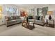 Bright living room featuring comfortable seating and natural light from the windows at 5845 W Portland Dr, Littleton, CO 80128