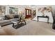 Cozy living room with plush seating, a large window, and staircase at 5845 W Portland Dr, Littleton, CO 80128