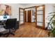 Open office showing hardwood floors, light walls, and French doors that provide an inviting and airy feel at 5845 W Portland Dr, Littleton, CO 80128