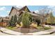 Nicely landscaped corner lot featuring mature trees, bushes, decorative grasses, and mulch beds at 15711 Josephine Cir, Brighton, CO 80602