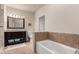Bright bathroom featuring a soaking tub and a dark vanity with double sinks at 3577 Molly Cir, Broomfield, CO 80023