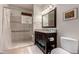 Cozy bathroom featuring a tiled shower, dark vanity, and neutral decor at 3577 Molly Cir, Broomfield, CO 80023