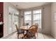 Cozy dining area features a wooden table with chairs, large windows, and natural light at 3577 Molly Cir, Broomfield, CO 80023