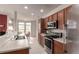 Well-lit kitchen with stainless steel appliances, wooden cabinets and adjacent dining area at 3577 Molly Cir, Broomfield, CO 80023