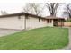 Spacious backyard with lush green lawn and white brick ranch-style home, perfect for outdoor entertaining at 4395 Newland St, Wheat Ridge, CO 80033