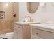 Bright bathroom featuring double vanities with modern fixtures and a luxurious glass-enclosed shower at 4395 Newland St, Wheat Ridge, CO 80033