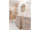 Bright bathroom featuring a glass enclosed shower, white tile floor, and double vanity with marble countertops at 4395 Newland St, Wheat Ridge, CO 80033