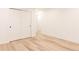 Minimalist bedroom with wood floors, closet, and abundant natural light at 4395 Newland St, Wheat Ridge, CO 80033