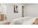 Cozy bedroom featuring light wood floors and an en-suite bathroom for added convenience at 4395 Newland St, Wheat Ridge, CO 80033