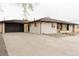 Spacious home exterior featuring a large driveway and an attached garage at 4395 Newland St, Wheat Ridge, CO 80033