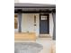 Charming home entrance with a black front door, decorative address numbers, and a well-maintained walkway at 4395 Newland St, Wheat Ridge, CO 80033