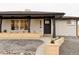 Charming home exterior with black trim, light brick, manicured landscaping, and welcoming front door at 4395 Newland St, Wheat Ridge, CO 80033