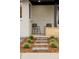Welcoming front porch featuring modern chairs and a serene garden setting with stone pathways at 4395 Newland St, Wheat Ridge, CO 80033