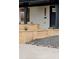 Landscaped front yard featuring modern raised wooden beds, gravel, and stone pavers at 4395 Newland St, Wheat Ridge, CO 80033