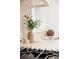Close-up of a kitchen counter with decorative elements, a vase, a marble mortar, and an open cookbook at 4395 Newland St, Wheat Ridge, CO 80033