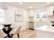Bright kitchen and dining area with stainless steel appliances, a glass-top table, and modern finishes throughout at 4395 Newland St, Wheat Ridge, CO 80033
