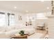 Bright living room with large windows, neutral decor, and an open layout to the kitchen at 4395 Newland St, Wheat Ridge, CO 80033
