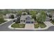 Aerial view of a blue two-story home with a three-car garage surrounded by trees and greenery in a residential area at 12430 S Downy Creek Ct, Parker, CO 80134