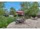 Spacious backyard with stone patio featuring outdoor dining and fire pit areas, perfect for entertaining and relaxation at 12430 S Downy Creek Ct, Parker, CO 80134
