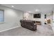 Finished basement featuring a comfortable seating area with a large TV and cozy carpeting at 12430 S Downy Creek Ct, Parker, CO 80134