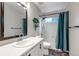 Cozy bathroom featuring a shower-tub, vanity with framed mirror, toilet, and decorative house plant at 12430 S Downy Creek Ct, Parker, CO 80134