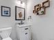 Stylish powder room features modern vanity, sleek fixtures, decorative shelving, and contemporary decor, with ample natural light at 12430 S Downy Creek Ct, Parker, CO 80134