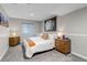 Cozy bedroom featuring a queen bed, soft lighting, neutral carpet, and art at 12430 S Downy Creek Ct, Parker, CO 80134