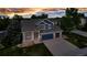 Beautiful two-story home boasts a three-car garage, a welcoming front porch, and a well-manicured lawn at 12430 S Downy Creek Ct, Parker, CO 80134