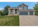 Beautiful two-story home with a covered porch, three-car garage, and well-maintained lawn at 12430 S Downy Creek Ct, Parker, CO 80134