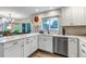 Stylish kitchen featuring white cabinets, stainless steel appliances, and open access to dining area at 12430 S Downy Creek Ct, Parker, CO 80134