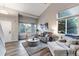 Bright living room featuring vaulted ceilings, large windows, and modern decor, creating an inviting space at 12430 S Downy Creek Ct, Parker, CO 80134