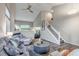Inviting living room features a cozy gray sofa, round coffee table, and a staircase leading to the upper level at 12430 S Downy Creek Ct, Parker, CO 80134