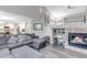 Spacious living room features a fireplace, comfortable sofa, and open layout, perfect for entertaining at 12430 S Downy Creek Ct, Parker, CO 80134