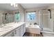 Elegant main bathroom with double sinks, soaking tub, separate shower, and bright natural light, creating a spa-like atmosphere at 12430 S Downy Creek Ct, Parker, CO 80134