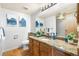 Well-lit bathroom with granite countertop, wood cabinets, and decorative accents, creating a cozy atmosphere at 942 S Walden St # 204, Aurora, CO 80017