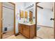 Cozy bathroom featuring a vanity with wood cabinets, a sink, and bright lighting at 942 S Walden St # 204, Aurora, CO 80017