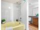 This bathroom showcases a unique yellow tub with white tile surround and modern fixtures at 942 S Walden St # 204, Aurora, CO 80017