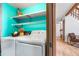 Laundry room with white appliances, shelving and access to living room at 942 S Walden St # 204, Aurora, CO 80017