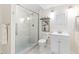 Bright bathroom featuring a glass shower door, white tiling, and modern fixtures at 2017 N Fork Dr, Lafayette, CO 80026